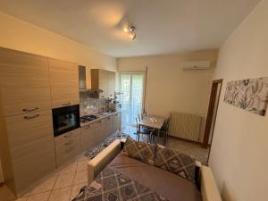 a living room with a couch and a kitchen at Holiday Home Villanova in Ponte Lucano