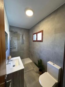 a bathroom with a toilet and a sink at El Balcón de Villablancas in La Manga del Mar Menor +32 photos