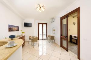 a living room with a table and a dining room at Hotel La Darsena in San Vito lo Capo