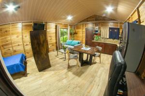 a kitchen and dining area of a tiny house at ParadiseTropical Garden Cabin with private jacuzzi in Fortuna