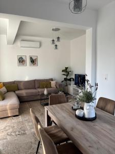 a living room with a table and a couch at Marisa in Ierapetra