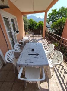 a white table and chairs on a balcony at Apartman Relax in Bijela +3 photos