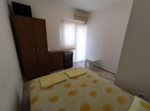 a room with a bed with two towels on it at Apartman Relax in Bijela