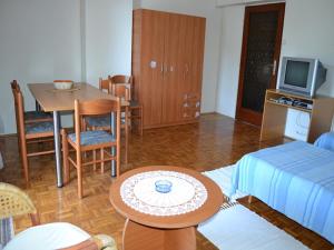 a living room with a table and a dining room at Apartments Sun Gardens in Privlaka