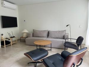 a living room with a couch and chairs and a table at Imōto estadía en el corazón de Chacras de Coria in Chacras de Coria