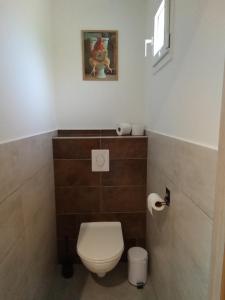 a bathroom with a toilet and a picture on the wall at La CHANTERELLE in Mortagne +9 photos