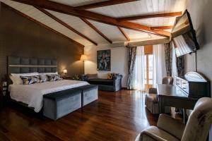 a bedroom with a bed and a living room at Agriturismo Villa Godenano - Pool&Restaurant in Castellina in Chianti +117 photos