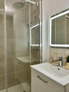 a bathroom with a shower and a sink and a mirror at Cosy flat with view in Asnières-sur-Seine +3 photos
