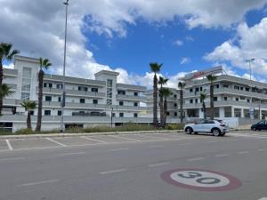 a car parked in a parking lot in front of a building at House Nereide, Lovely Apartment Sea View GALLIPOLI in Gallipoli