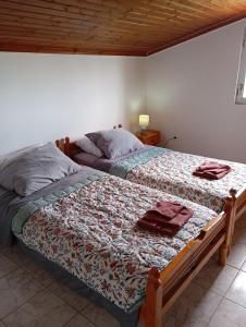 a bed in a bedroom with a wooden ceiling at THE PALM ROOMs in Preveza