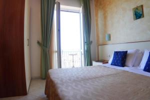 Postel nebo postele na pokoji v ubytování New Hotel Sonia