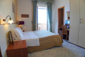 Postel nebo postele na pokoji v ubytování New Hotel Sonia