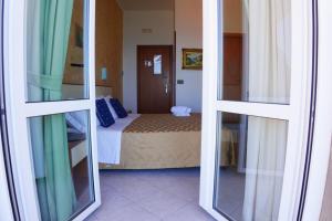 Postel nebo postele na pokoji v ubytování New Hotel Sonia
