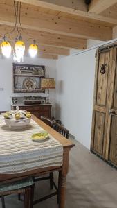 a kitchen with a table with a bowl of fruit on it at Le Mennule 26 in Alliste