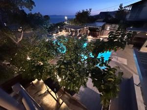 an overhead view of a pool with a tree and lights at Magic View 4U Luxury Villa, Tago Vibes in Kineta