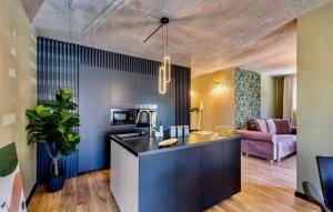a kitchen with a counter and a living room at Luxury Apartments with Private Pool and Sauna or with jacuzzi near Split , Sea View in Podstrana