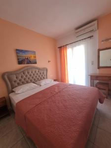a bedroom with a large bed and a window at Sun Ray Sivota 8 in Syvota