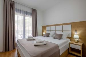 Postel nebo postele na pokoji v ubytování Apartments BB + 26 fotografií