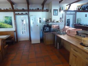 a kitchen with a counter and a refrigerator at Landhotel Auerose Garni in Neu Kosenow