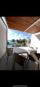 a patio with a table and chairs and a view of the ocean at Marina Bay Apartament 1 in Vlorë