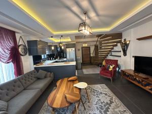 a living room with a couch and a table at Villa Yılmaz dream holiday in Kuşadası