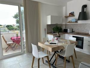 a kitchen and dining room with a table and chairs at Dimora La Mennula in Leverano
