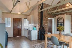 a kitchen and dining room with a table and a stove at Welverdiend - Unit 2 in Bloemfontein