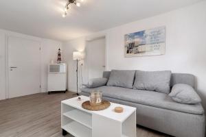 a living room with a couch and a table at Ferienwohnungen Derday in Friesenheim