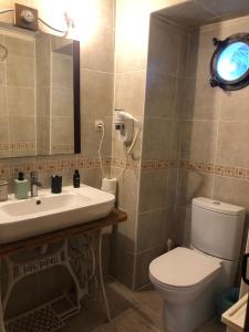 a bathroom with a sink and a toilet and a mirror at Antalya kaleiçi müstakil kişiye özel bahçeli müstakil VİLLA in Antalya +65 photos