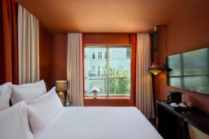 a hotel room with a bed and a window at Casa Suzanna Hotel in Tel Aviv +46 photos