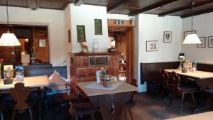 a restaurant with tables and chairs in a room at Schwaigeralm in Kreuth