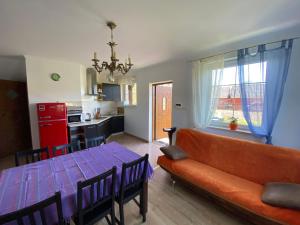 a living room with a couch and a table at Barwy Lata in Rowy
