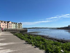 a row of houses next to a body of water at The Snug self contained apartment in Killyleagh