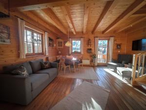 a living room with a couch and a table at Almhütte Falkert in Patergassen