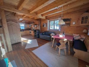 a living room with a table in a log cabin at Almhütte Falkert in Patergassen