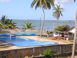 a swimming pool with a view of the ocean at Red Coral Village Kitesurfing School in Kalpitiya