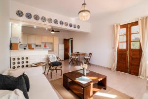 a living room with a couch and a table at Villa Panagiota, Pefkos in Pefki