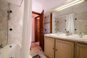 a bathroom with two sinks and a tub and a shower at Villa Panagiota, Pefkos in Pefki Rhodes +50 photos