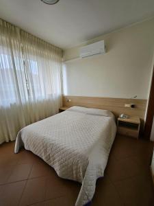 Postel nebo postele na pokoji v ubytování Albergo Nyers