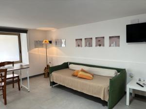 a bedroom with a green bed with two pillows on it at B&B IL GIRASOLE in Maddaloni