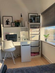 an office with a desk with a computer and a chair at Small but cozy 1 bedroom Apartment with Living room in Hvidovre