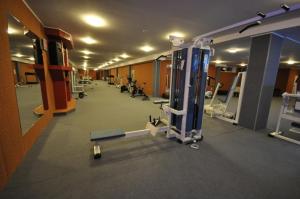 a gym with rows of equipment in a room at Hotel Šiauliai in Šiauliai