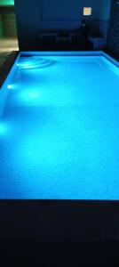 a pool table with blue lights on top of it at Casa Vargas Veracruz in Antón Lizardo