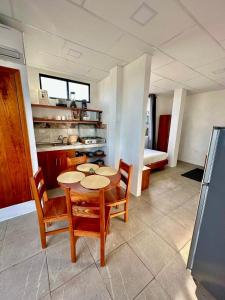 a kitchen with a table and chairs in a room at Family-friendly with balcony and terrace in Puerto Ayora