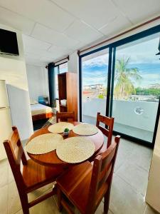 a dining room with a table and a view of the ocean at Family-friendly with balcony and terrace in Puerto Ayora