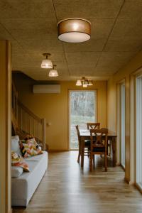 a living room with a bed and a table and a couch at Rītu atpūtas namiņi in Talsi