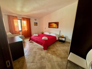 a bedroom with a red bed in a room at Villetta Saba in Olbia +23 photos