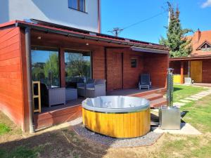 a large wooden tub sitting outside of a house at Apartement u Jędrusia w ogrodzie in Żywiec +15 photos