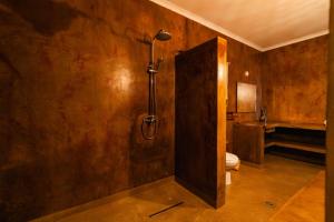 a bathroom with a shower and a toilet in it at Micala Lodge in Lago +48 photos