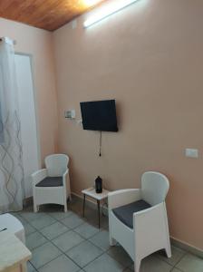 a room with two chairs and a flat screen tv at Casa Natura in Avola +42 photos